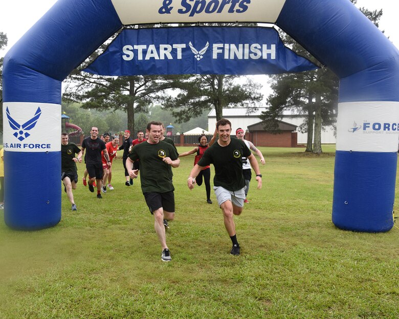 Teams run across the finish line during the A-BLAZIN’ Race May 10, 2019, on Columbus Air Force Base, Miss. Nearly 230 people participated in the wing-wide physically challenging event.  (U.S. Air Force Base by Sharon Ybarra)