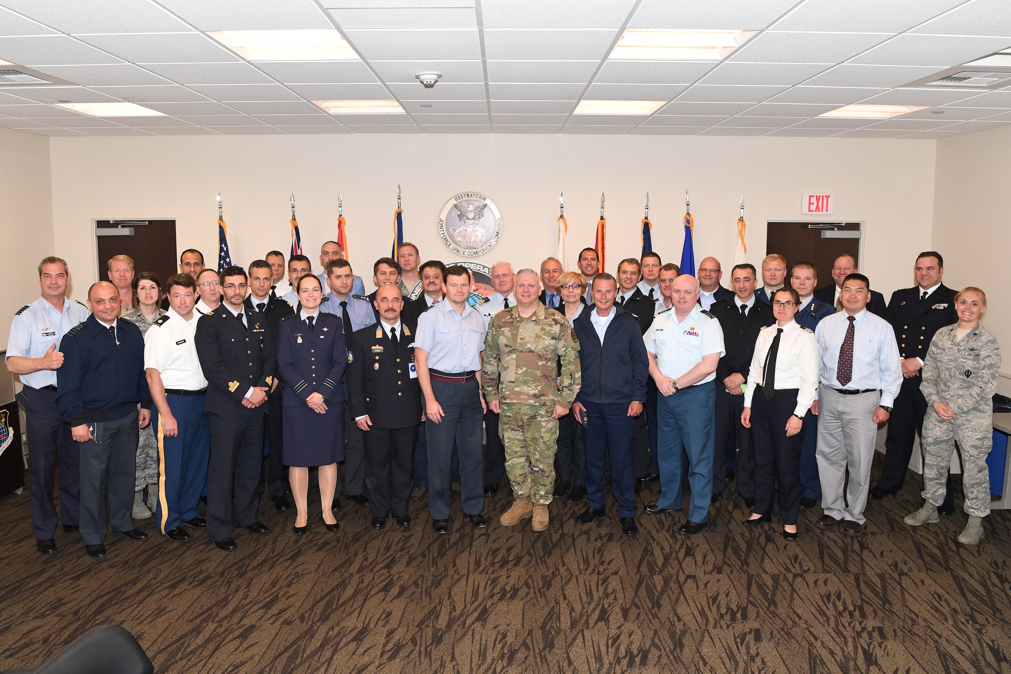 North Atlantic Treaty Organization (NATO) officials pose for a photo with service members from the Joint Force Space Component Command following a Combined Space Operations Center (CSpOC) mission brief at Vandenberg AFB, Calif., May 16, 2019.