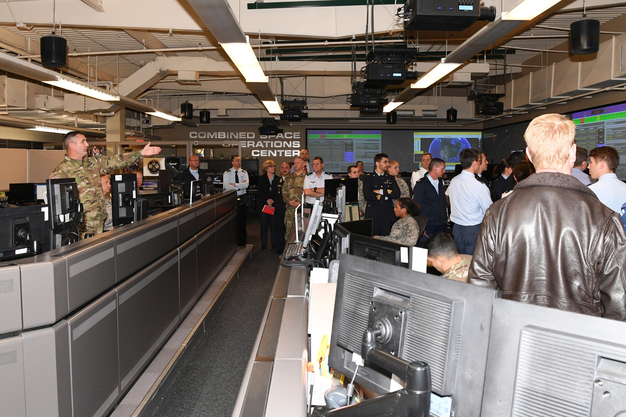 U.S. Army Maj. Matthew Fechter, Chief of Current Operations, Combined Space Operations Center (CSpOC), discusses space operations and capabilities with North Atlantic Treaty Organization (NATO) officials during a tour of the CSpOC at Vandenberg AFB, Calif., May 16, 2019.