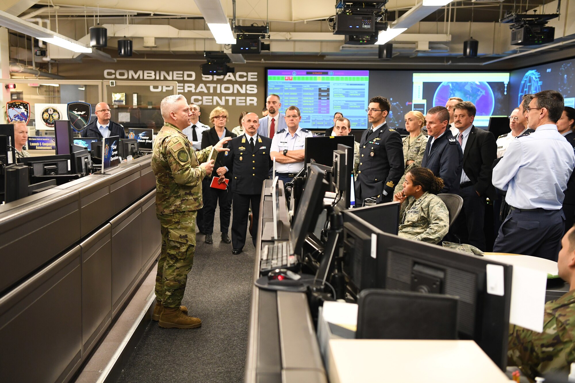Col. Scott Brodeur, Director, Combined Space Operations Center (CSpOC), discusses space operations and capabilities with North Atlantic Treaty Organization (NATO) officials during a tour of the CSpOC at Vandenberg AFB, Calif., May 16, 2019.