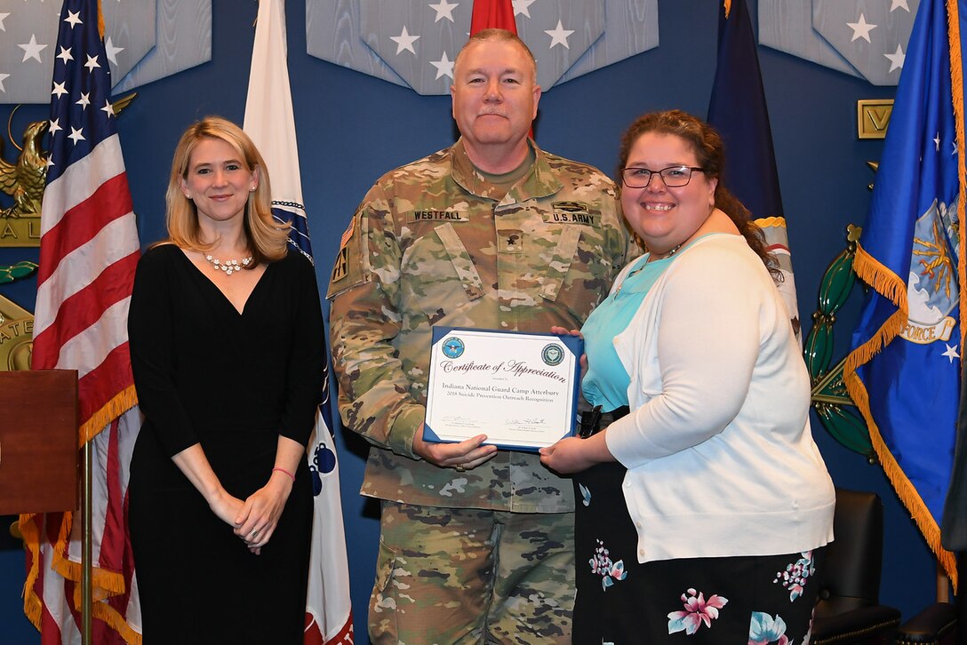 Award recipients hold a certificate.