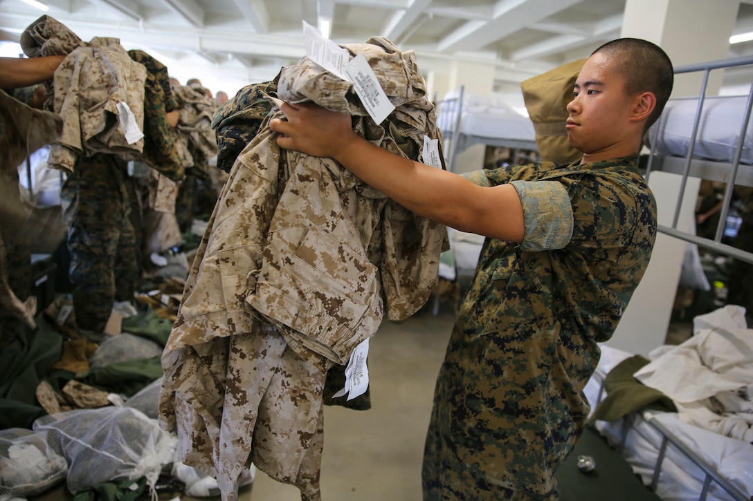 Men pick up military uniforms.