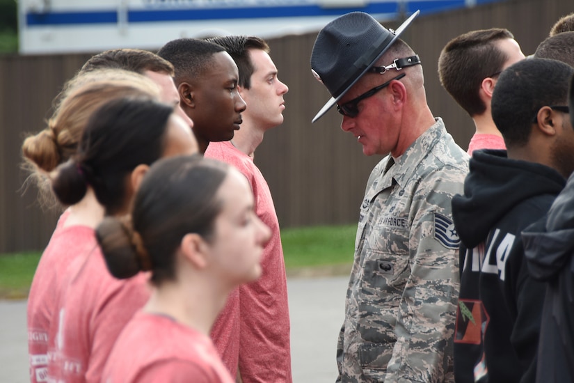 An airman inspects new recruits.