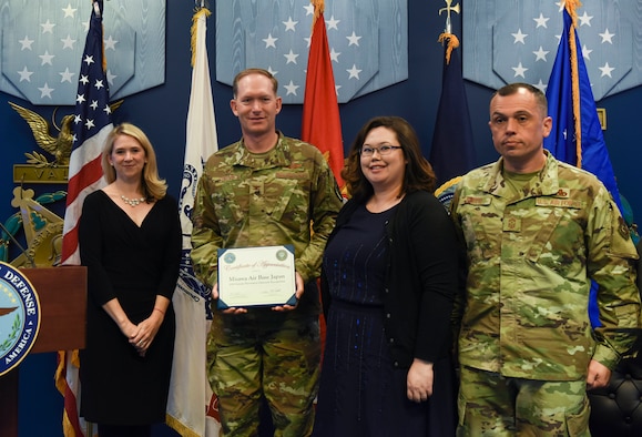 Col. Kristopher Struve, Misawa Air Base, Japan Wing commander, Command Chief Master Sgt. John C. Alsvig and Ms. Michelle Aldana accept a certificate of appreciation from Dr. Elizabeth P. Van Winkle, executive director, Office of Force Resiliency during the 2018 Defense Suicide Prevention Month recognition ceremony at the Pentagon, in Arlington, Va., May 15, 2019. Misawa AB was recognized by DoD two years in a row for suicide prevention outreach. (U.S. Air Force photo by Tech Sgt. Anthony Nelson Jr.)