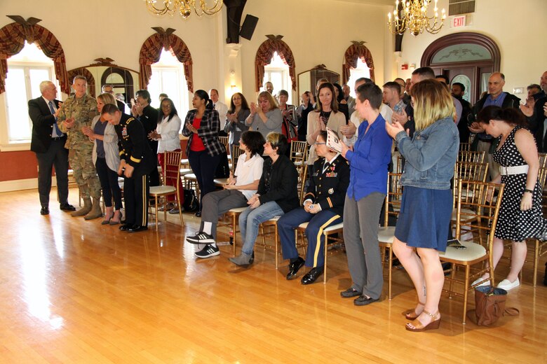 Ceremony attendees give Lt. Col. Julie D'Annunzio a standing ovation following remarks at her retirement ceremony held May 10, at the Fort Hamilton Community Club's Washington Room in Brooklyn, New York.