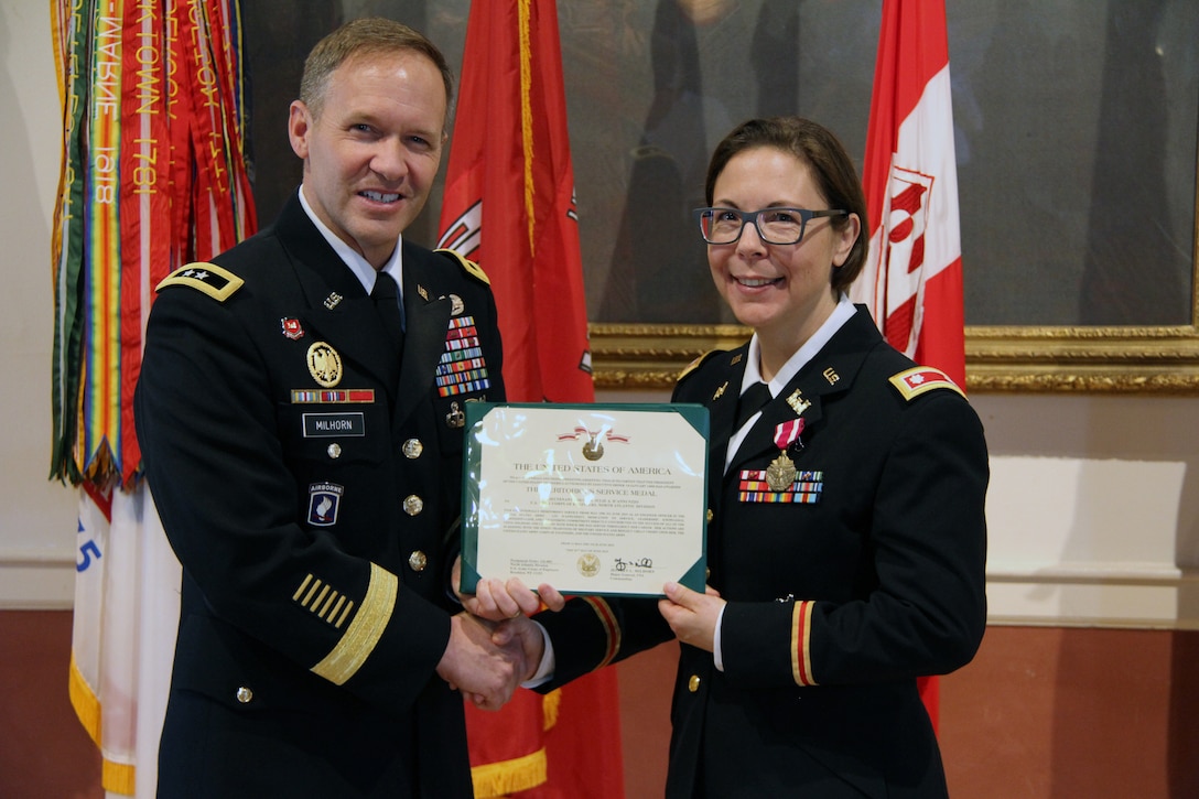 U.S. Army Corps of Engineers North Atlantic Division (NAD) Commander Maj. Gen. Jeffrey Milhorn presents Lt. Col. Julie D'Annunzio with a certificate to accompany the Meritorious Service Medal she received as an end-of-service award at her retirement ceremony held May 10, at the Fort Hamilton Community Club's Washington Room in Brooklyn, New York.