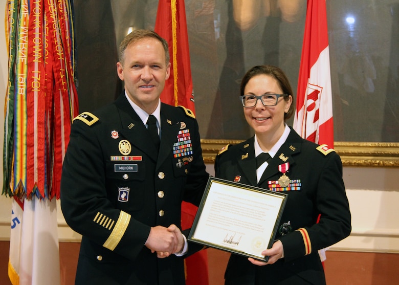 U.S. Corps of Engineers North Atlantic Division (NAD) Commander Maj. Gen. Jeffrey Milhorn (left) presents a certificate of appreciation from President Donald Trump to Lt. Col. Julie D'Annunzio (right) during her retirement ceremony held May 10, at the Fort Hamilton Community Club's Washington Room in Brooklyn, New York.