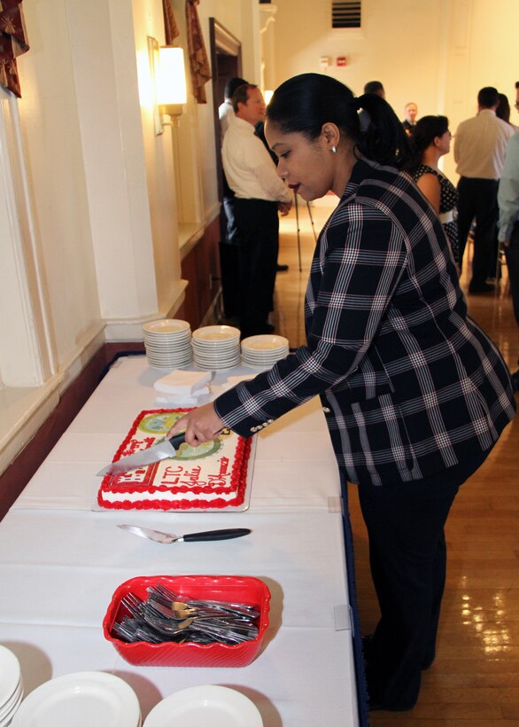 North Atlantic Division (NAD) employee Shamirra Shelton-Thornton cut a cake following a retirement ceremony honoring Lt. Col. Julie D'Annunzio.