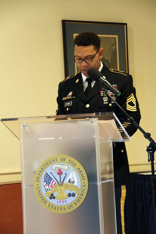 Master Sgt. David Foster narrates during a retirement ceremony honoring Lt. Col. Julie D'Annunzio held May 10, at the Fort Hamilton Community Club's Washington Room in Brooklyn, New York.
