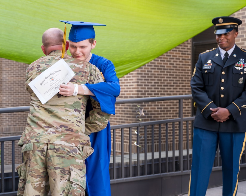 Army Future Soldier Justin Dees shares an embrace with Army recruiter Staff Sgt. Cory Barnes after receiving his diploma from William Blount High School. (Photo Credit: East Tennessee Childrens Hospital)