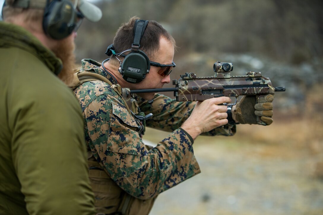 A U.S. Marine with 1st Reconnaissance Battalion, 1st Marine Division, fires an MP7 downrange amid a combat marksmanship drill during exercise Platinum Ren at Fort Trondennes, Harstad, Norway, May 15, 2019.