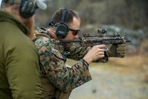 A U.S. Marine with 1st Reconnaissance Battalion, 1st Marine Division, fires an MP7 downrange amid a combat marksmanship drill during exercise Platinum Ren at Fort Trondennes, Harstad, Norway, May 15, 2019.