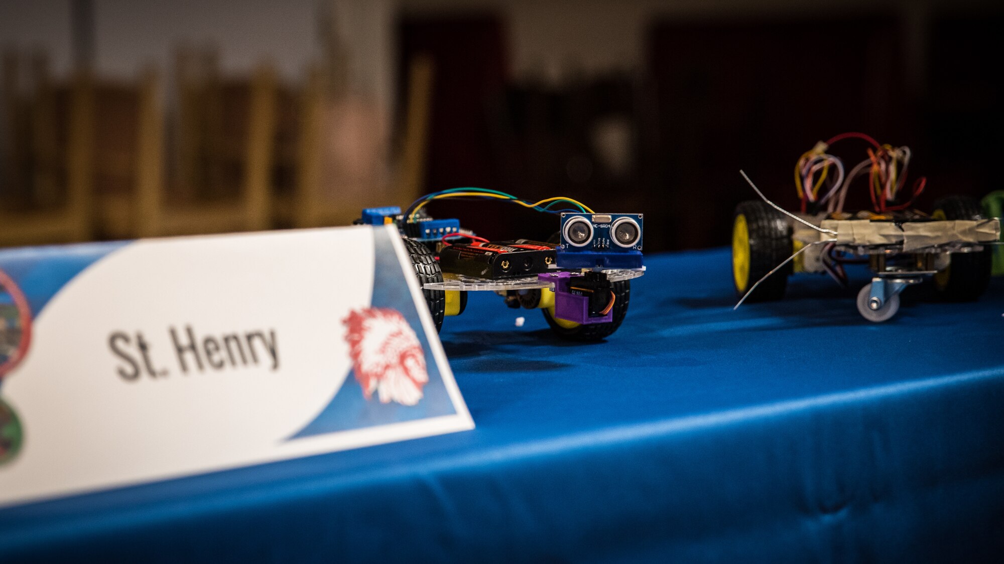 Autonomous vehicles, built by students from St. Henry High School, sit on a display table awaiting their races at the Air Force Research Laboratory's Full Throttle STEM at Eldora Speedway May 14. (U.S. Air Force photo/Richard Eldridge)