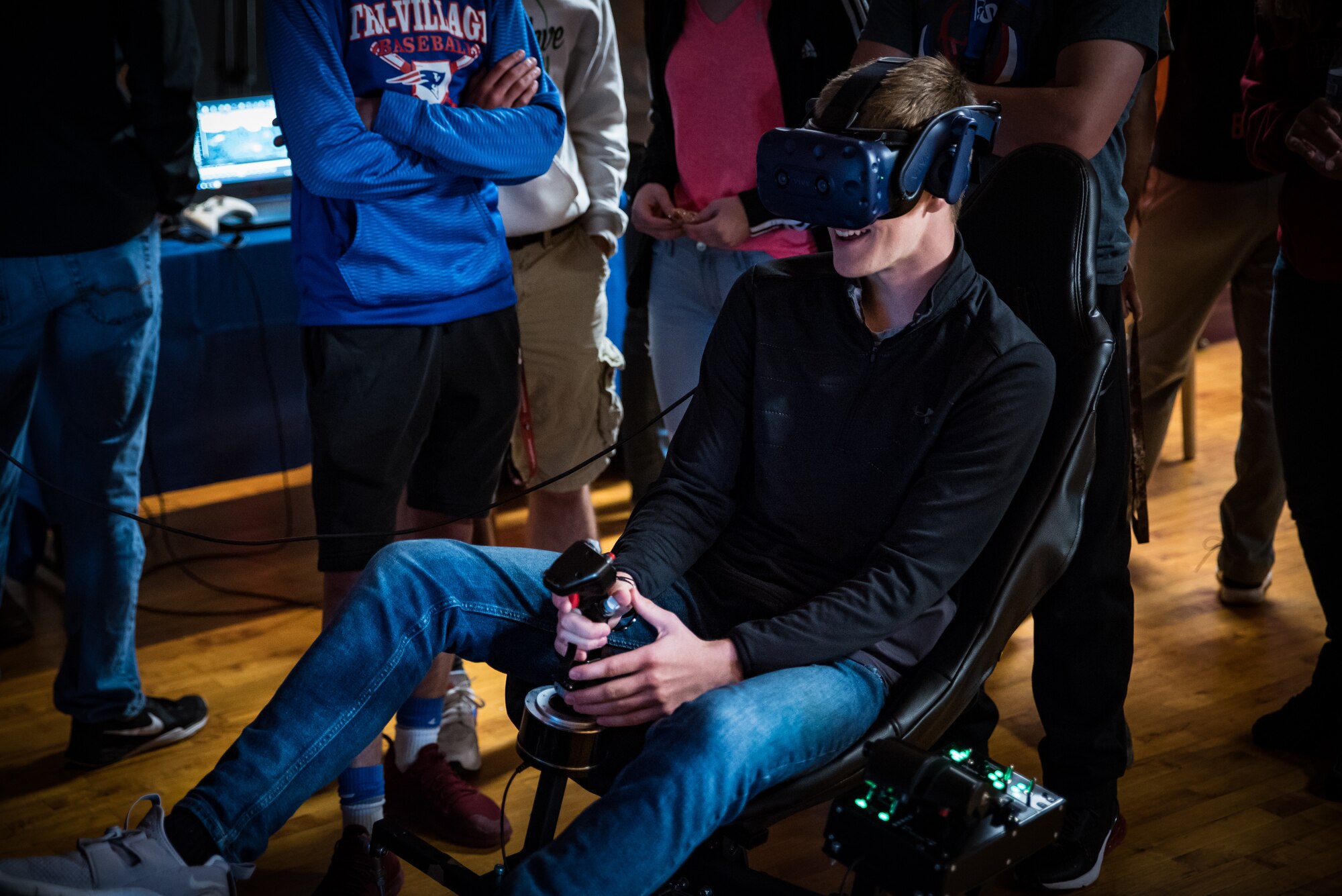 A student operates a jet simulator using virtual reality during the Air Force Research Laboratory’s 7th annual Full Throttle STEM at Eldora Speedway May 14. (U.S. Air Force photo/Richard Eldridge)