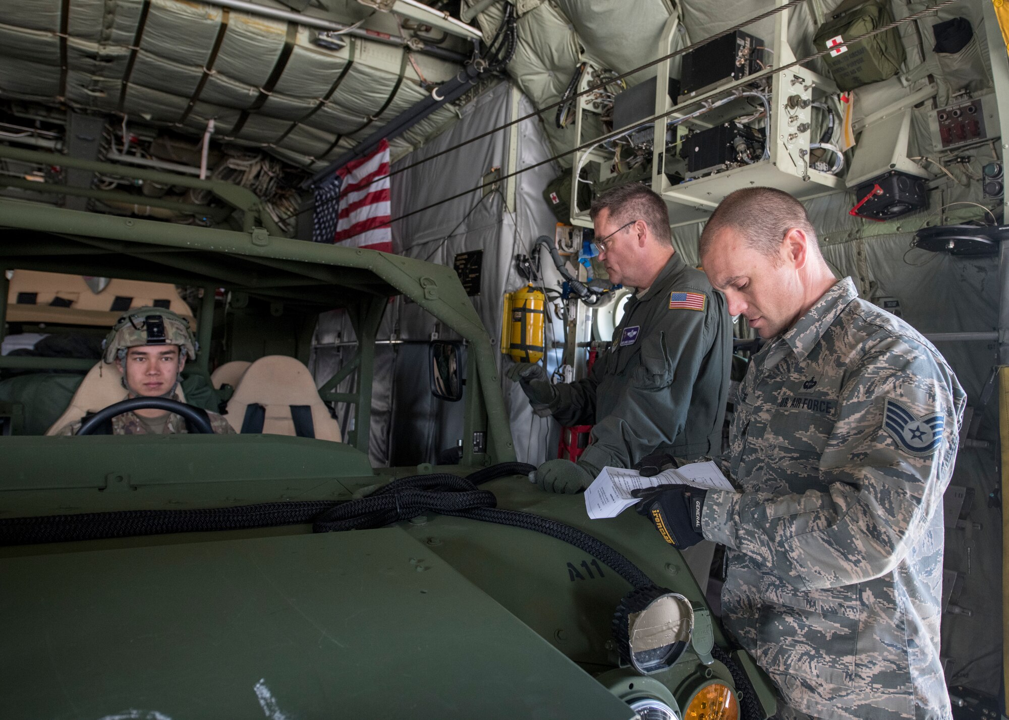 Staff Sgt. Christopher Biggs, 46th Aerial Port Squadron air transportation specialist, reviews weight, dimensions and tie-down points for a U.S. Army ground mobility vehicle inside a C-130H Hercules, operated by the 96th Airlift Squadron, 934th Airlift Wing, Minneapolis–St. Paul Joint Air Reserve Station, Minnesota, during Immediate Response 2019 May 14, 2019, at Aviano Air Base, Italy. Immediate Response highlights the inherent flexibility and strategic mobility of ground and air forces to rapidly respond to crises, allowing for the right presence where we need it, when we need it. (U.S. Air Force photo by Staff Sgt. Zachary Cacicia)