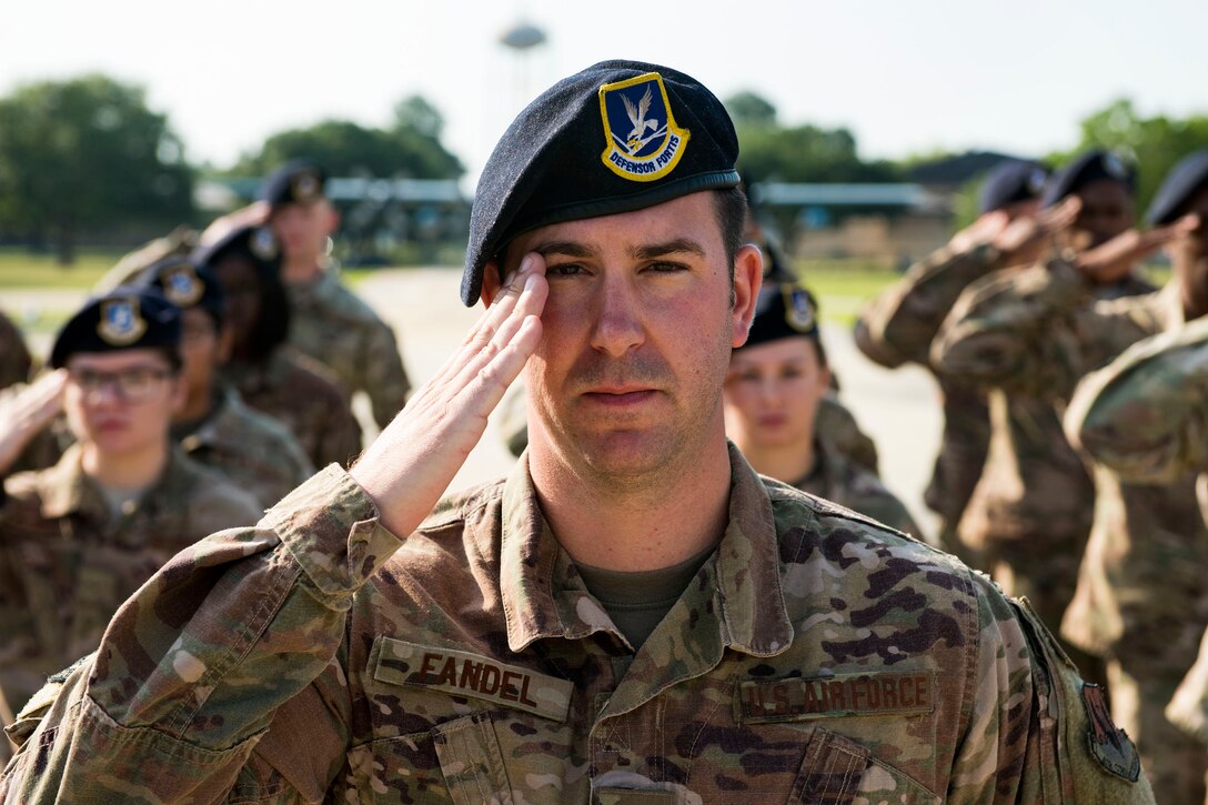 Airmen from 822d Base Defense Squadron render salutes during the National Anthem for the closing ceremony for Nation Police Week 2019, May 17, 2019, at Moody Air Force Base, Ga. The ceremony was a part of Moody’s support of National Police Week, to pay tribute to all law enforcement officers who serve and protect the united States with courage and dedication. (U.S. Air Force photo by Senior Airman Erick Requadt)
