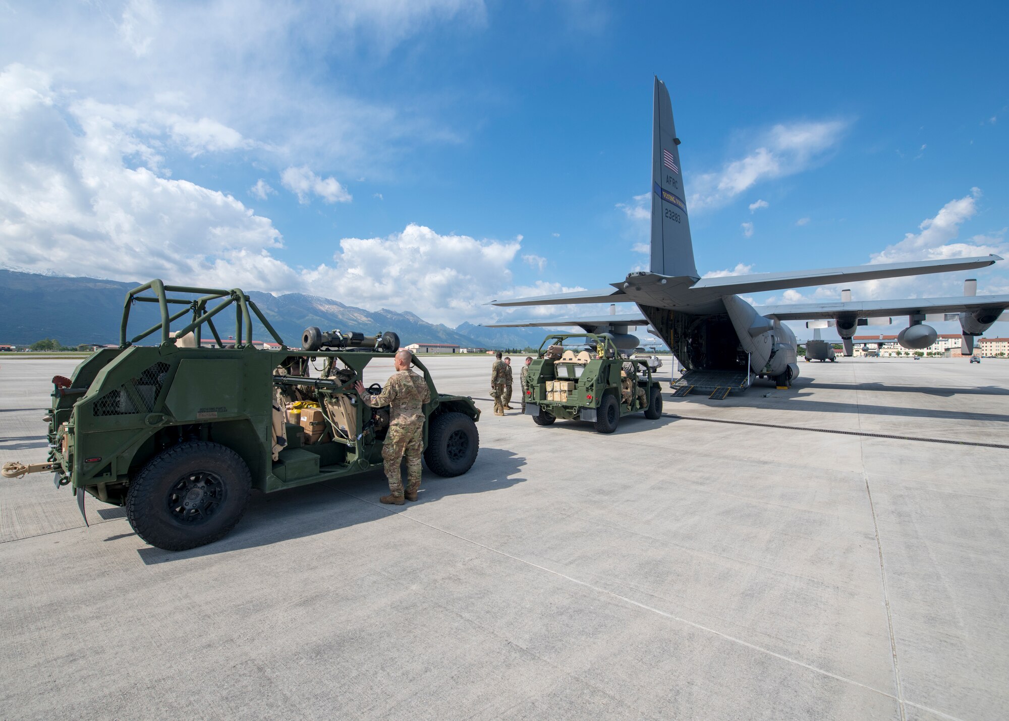 U.S. Army ground mobility vehicles sit on the flight line prior to being loaded onto a C-130H Hercules, operated by the 96th Airlift Squadron, 934th Airlift Wing, Minneapolis–St. Paul Joint Air Reserve Station, Minnesota, during Immediate Response 2019 May 14, 2019, at Aviano Air Base, Italy. The logistics-focused exercise is designed to test and improve the ability to move forces and equipment rapidly from one location to another. Immediate Response promotes regional security, while strengthening partner capabilities and fostering trust. (U.S. Air Force photo by Staff Sgt. Zachary Cacicia)