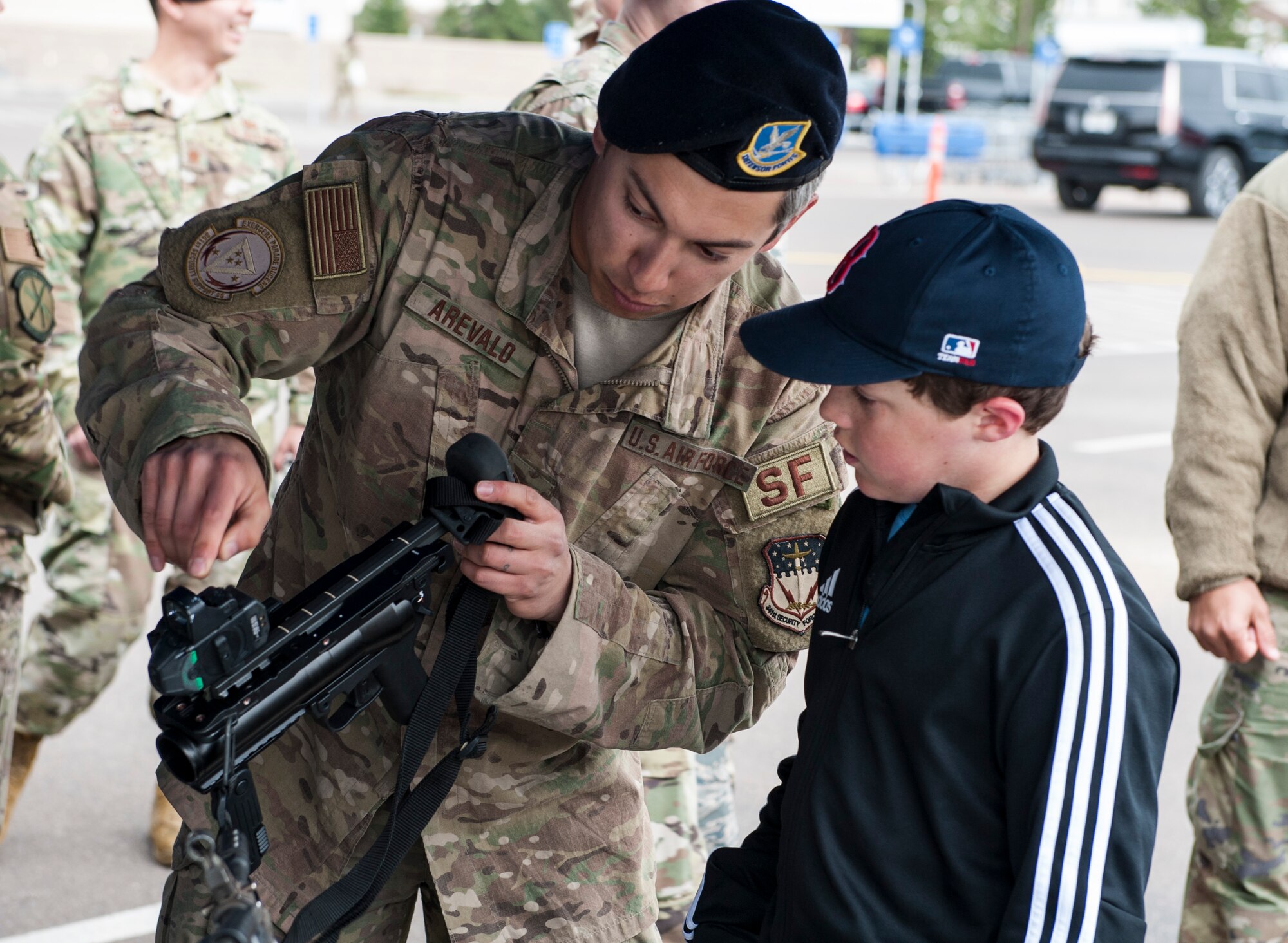 Senior Airman Tyler Arevalo, 741st Missile Security Forces Squadron tactical response force member, shows Gus Nurre, son of retired Master Sgt. Kevin Nurre, different weapon systems May 16, 2019, at Malmstrom Air Force Base, Mont.