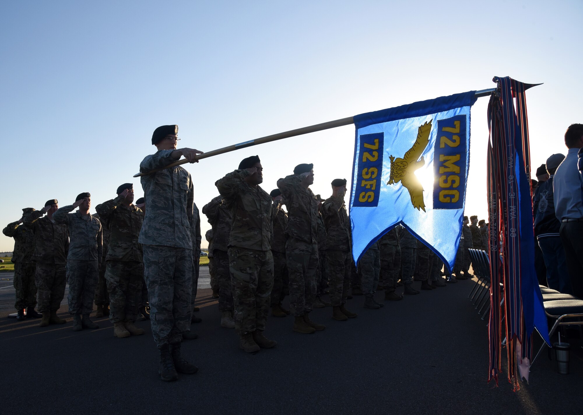 Members of the 72nd Security Forces Squadron salute in formation during Reveille in front of the 72nd Air Base Wing Headquarters building May 13. This week marks the annual Police Week, honoring the nation's and military's defenders and K-9 units who defend the country and those who have died in service.