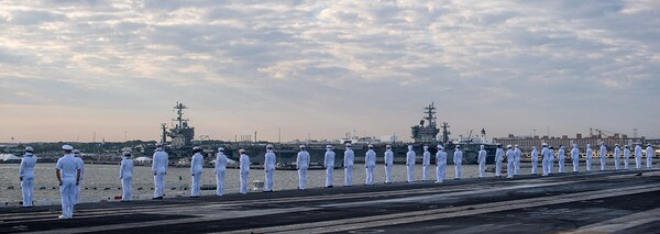 Sailors man the rails on the flight deck of the aircraft carrier USS John C. Stennis (CVN 74) while pulling into Norfolk, Virginia, May 16, 2019.