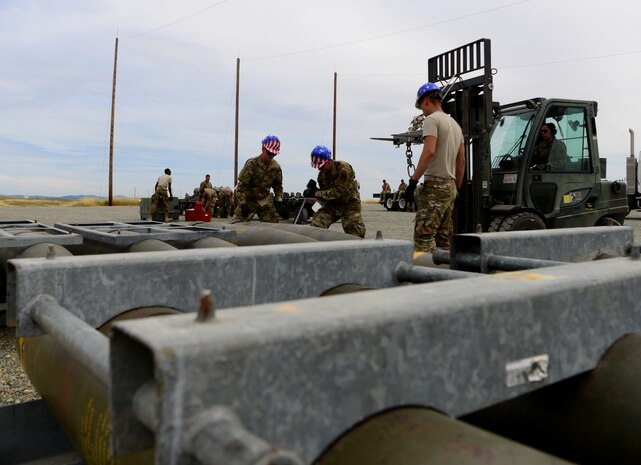 A photo of Airmen preparing to move munitions.