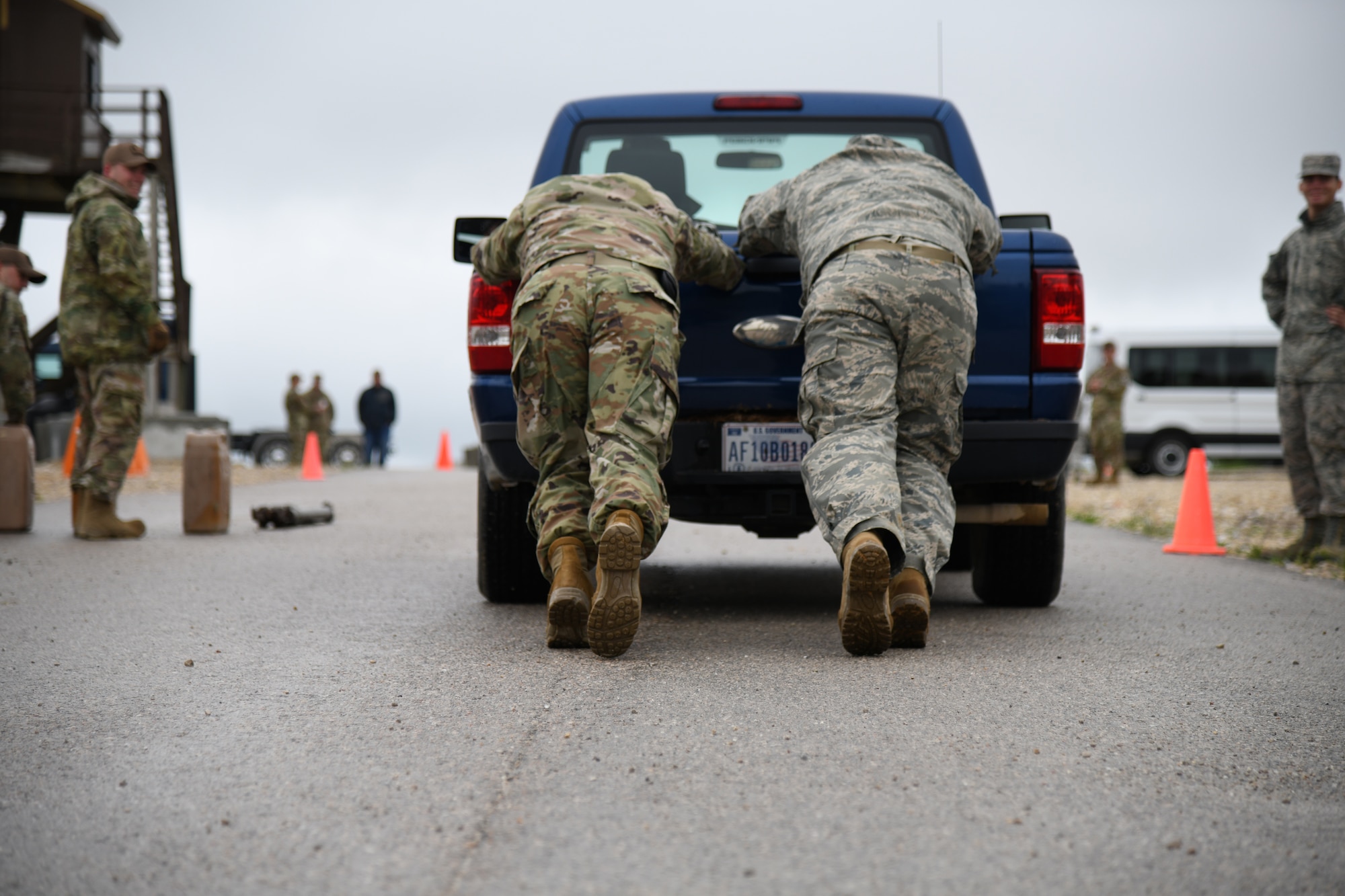 U.S. Air Force Airmen pushing truck