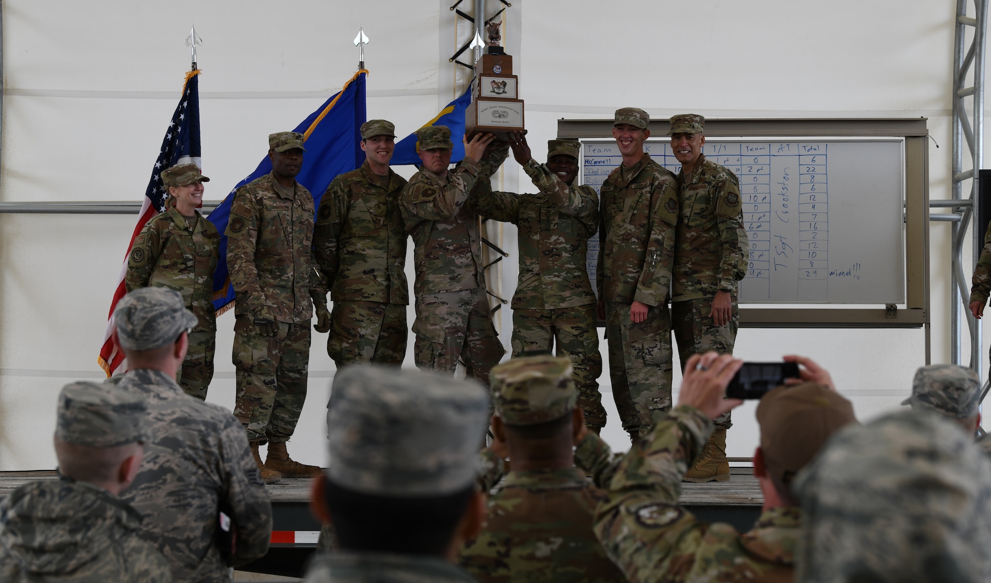 U.S. Air Force Airmen holding trophy