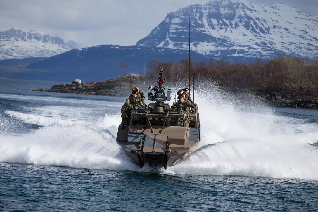 U.S. Marines with 1st Platoon, 1st Reconnaissance Battalion, 1st Marine Division, Marines with 1st Platoon, Force Reconnaissance Company, II Marine Expeditionary Force, and the Norwegian Coastal Ranger Commando (KJK) conduct CB90-class fast assault craft drills during exercise Platinum Ren at Fort Trondennes, Harstad, Norway, May 8, 2019.