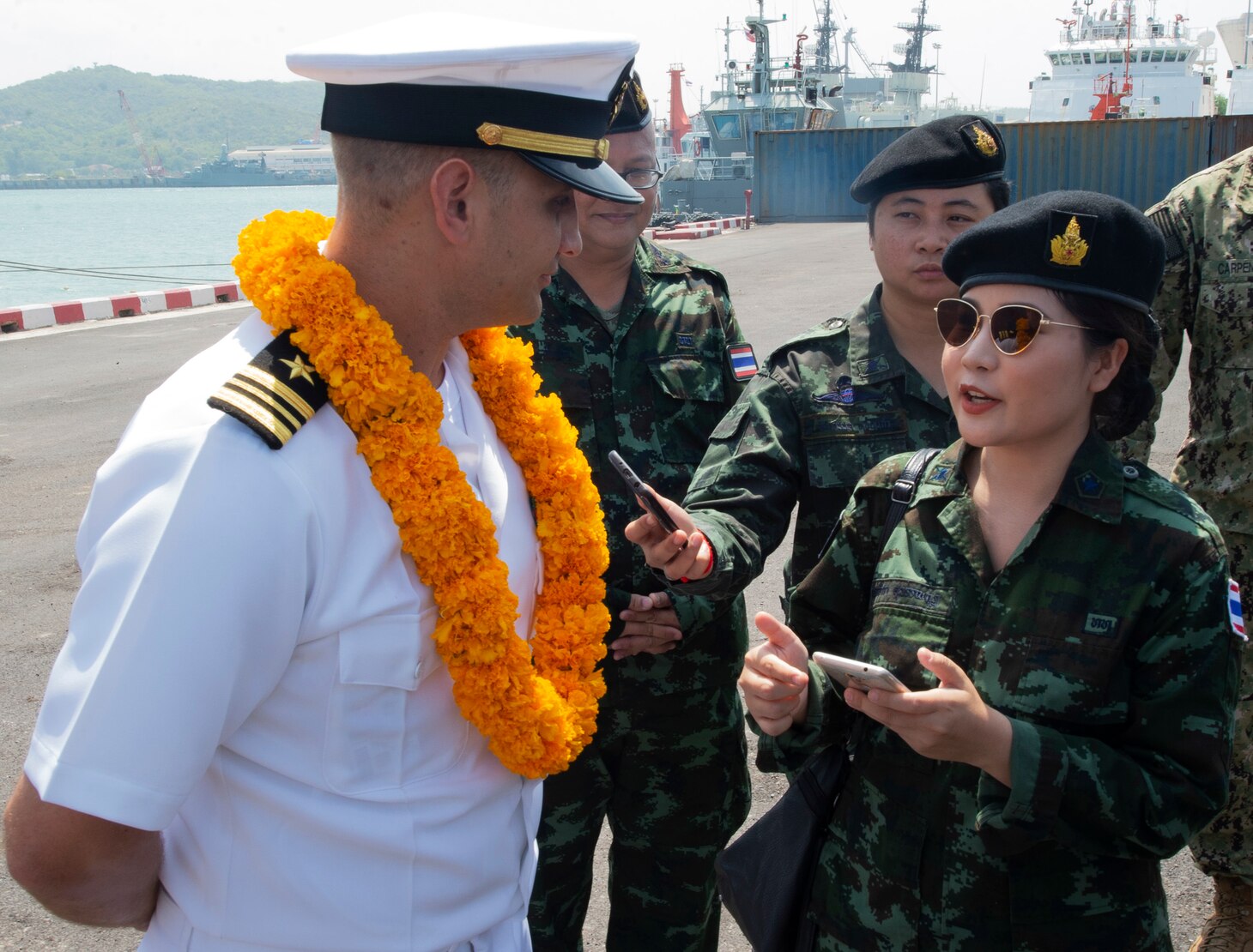 Sattahip, Thailand (May 18, 2019) – Royal Thai Navy 2nd Lt. Munlika Suwannasawad, Pacific Partnership 2019 (PP19) public relations officer, interviews U.S. Navy Lt. Cmdr. Nick Lyons, PP19 operations officer, following the arrival of the fast expeditionary transport ship USNS Fall River (T-EPF 4) in Thailand. Pacific Partnership, now in its 14th iteration, is the largest annual multinational humanitarian assistance and disaster relief preparedness mission conducted in the Indo-Pacific. Each year the mission team works collectively with host and partner nations to enhance regional interoperability and disaster response capabilities, increase security and stability in the region, and foster new and enduring friendships in the Indo-Pacific.