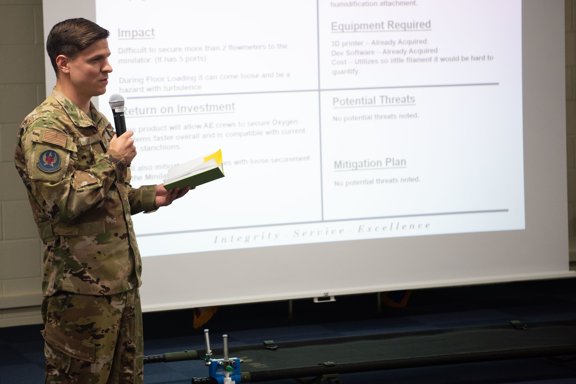 U.S. Air Force Staff Sgt. Dylan King, 18th Aeromedical Evacuation Squadron technician explains the potential innovation to 18th AES mission planning May. 10, 2019, at Kadena Air Base, Japan.