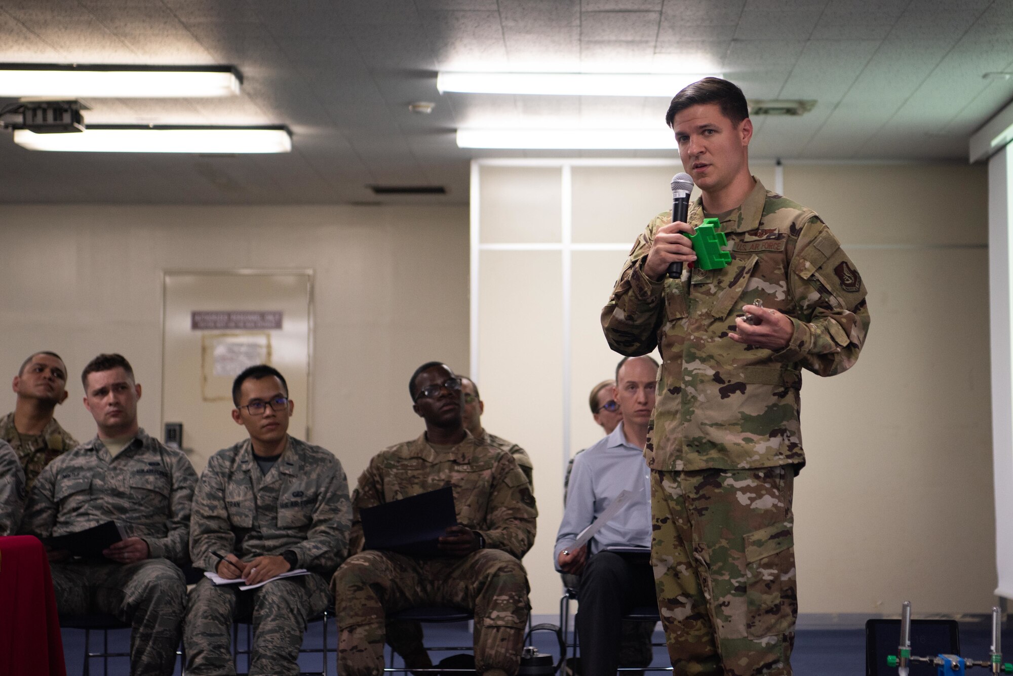 U.S. Air Force Staff Sgt. Dylan King, 18th Aeromedical Evacuation Squadron technician explains the potential innovation to 18th AES mission planning May. 10, 2019, at Kadena Air Base, Japan.