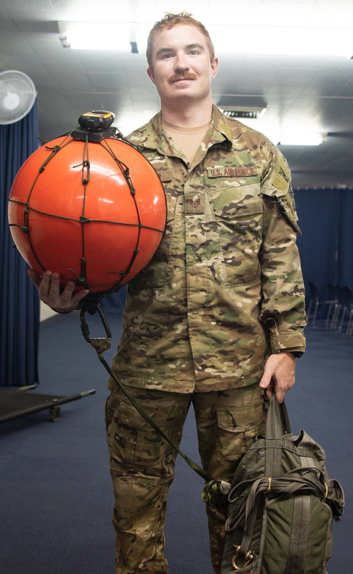 U.S. Air Force Staff Sgt. Gene Sauder, Air Force Special Operations Command case management system troop, poses with the Risilard drift beacon May.10, 2019, at Kadena Air Base, Japan.