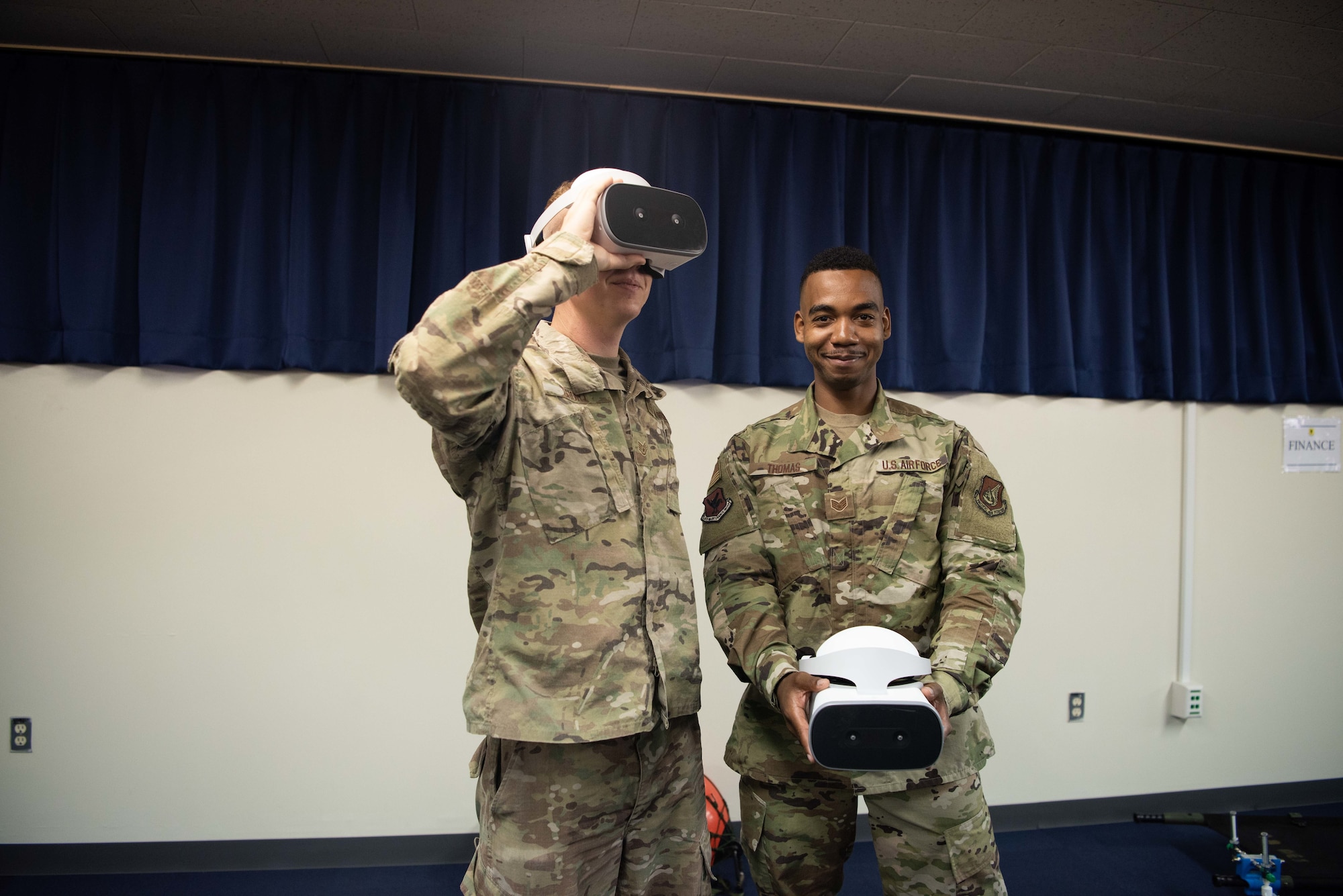 U.S. Air Force Staff Sgt. Matthew Short and Staff Sgt. Shamir Thomas, both 18th Maintenance Group KC-135 maintenance instructors, pose with their maintenance virtual reality training model, May.10, 2019, at Kadena Air Base, Japan.