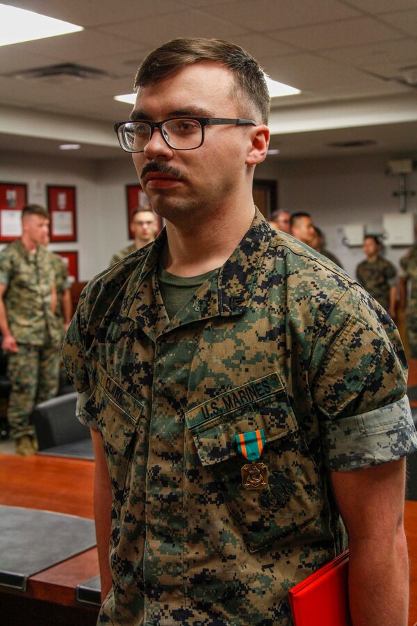 CAMP HUMPHREYS, Republic of Korea – Cpl. Jordan Clark, a plans and policy chief with Marines Forces Korea, receives the Navy and Marine Corps Achievement Medal as well as a Certificate of Commendation at an awards ceremony here, May 6. Clark was awarded the Navy and Marine Corps Achievement Medal for his accomplishments during his time with U.S. Marine Corps Forces Korea and received a Certificate of Commendation before being released to the ready reserve after serving honorably for four years in the Marine Corps. (Official U.S. Marine Corps photo by Sgt. Nathaniel Hanscom/Released)