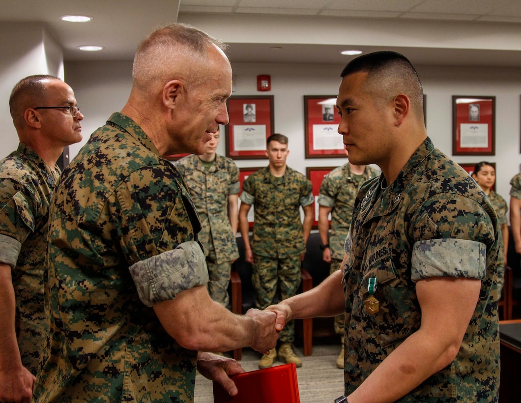 CAMP HUMPHREYS, Republic of Korea – Capt. Jason Ryu, U.S. Marine Corps Forces Korea exercise officer, is awarded the Navy and Marine Corps Commendation Medal during his awards ceremony here, May 8. Ryu received the Navy and Marine Corps Commendation Medal for his contributions to MARFORK, first serving as the aide de camp and finally as the exercise officer during his final months in Korea. (Official U.S. Marine Corps photos by Sgt. Nathaniel Hanscom/Released)