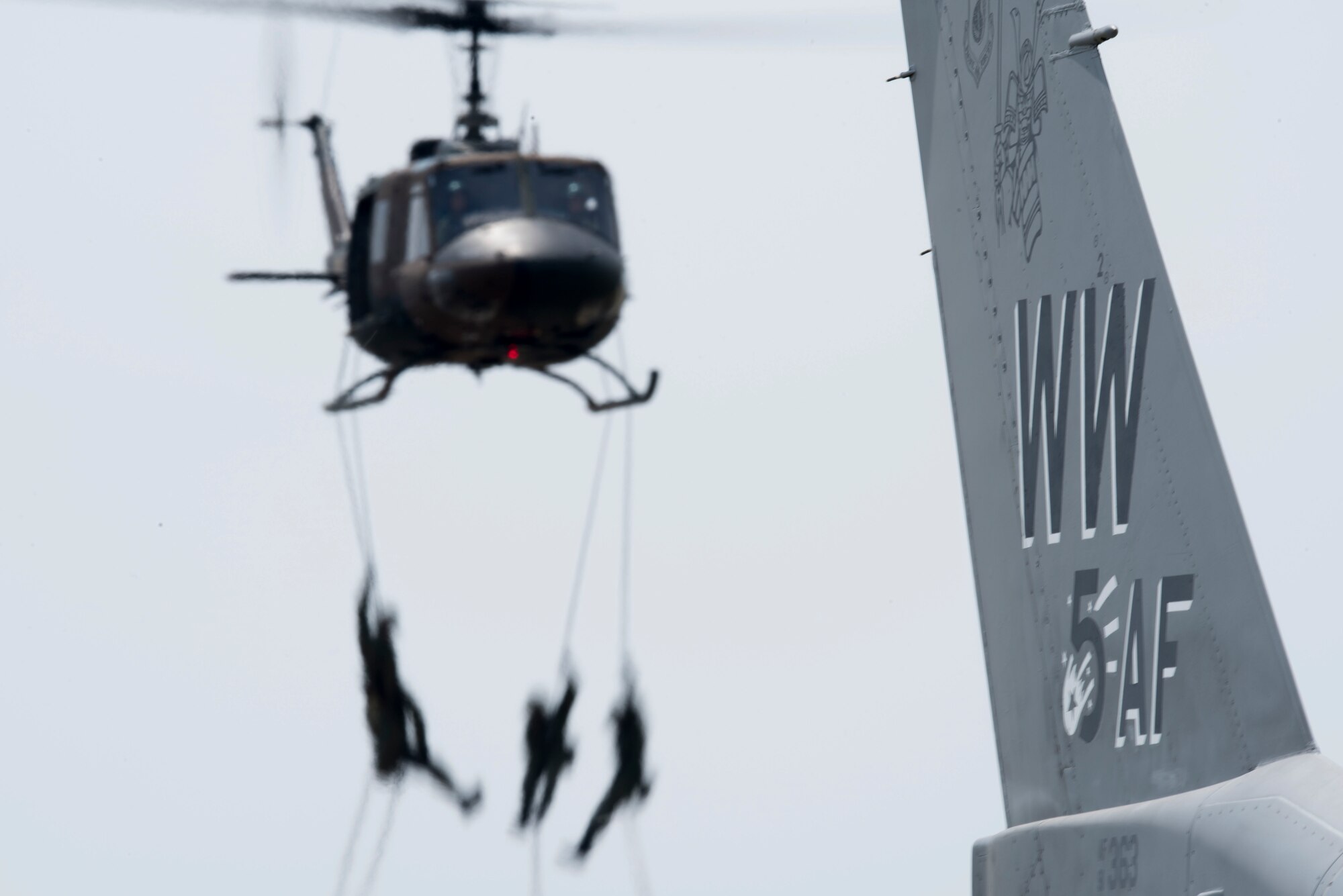 The Japan Ground Self-Defense Force conducts rappelling demonstrations beside an F-16 Fighting Falcon at the 43rd Japan Maritime Self-Defense Force – Marine Corps Air Station Iwakuni Friendship Day 2019 at MCAS Iwakuni, May 5, 2019. JGSDF used this technique to display their technical abilities and skills as performers and aviators. The event showcased dozens of performances by American and Japanese aircraft and pilots, including the Pacific Air Forces F-16 Fighting Falcon Demonstration Team. (U.S. Air Force photo by Senior Airman Collette Brooks)