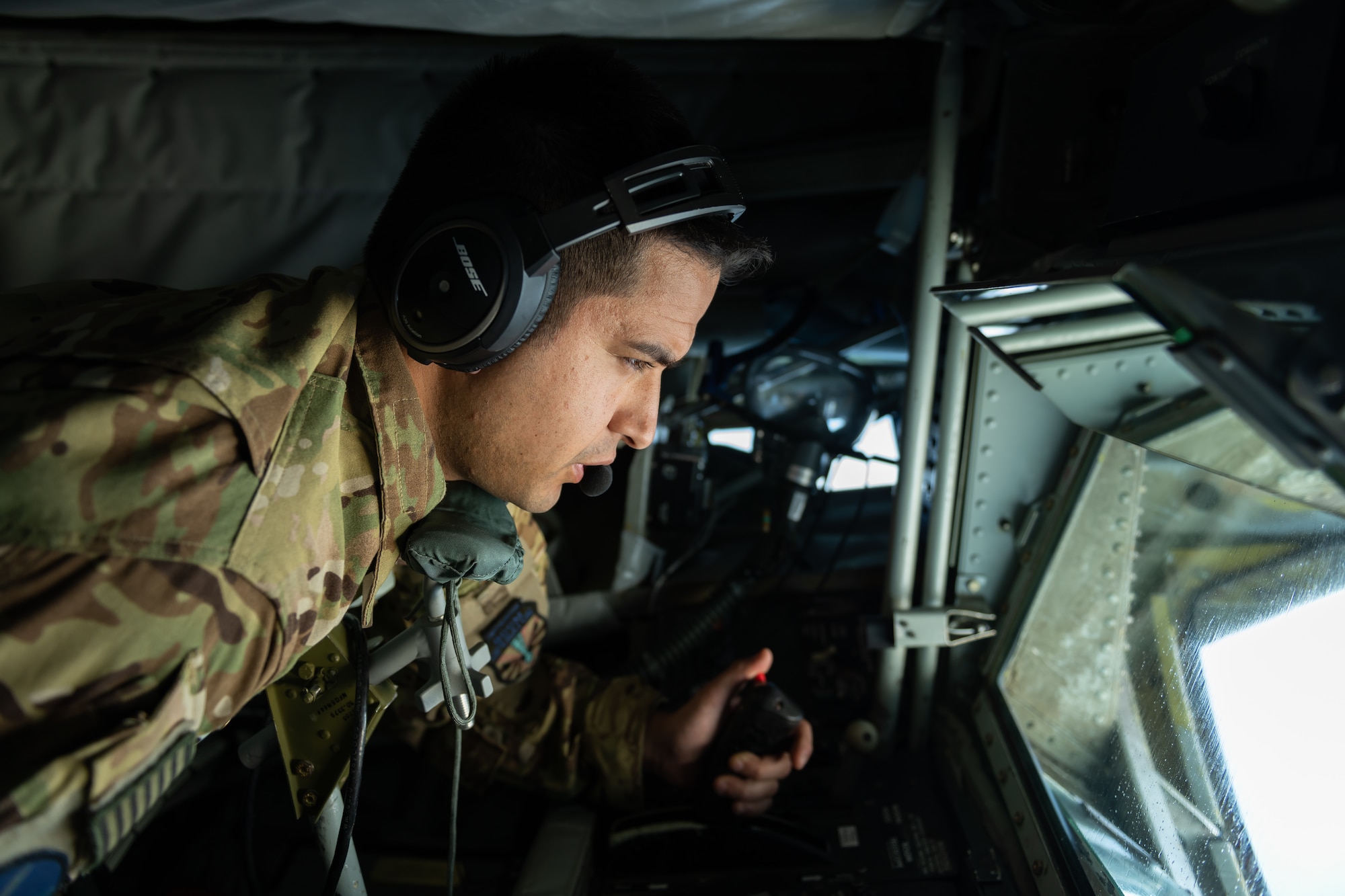 U.S. Air Force Technical Sergeant Chance Italiano, 18th Air Refueling Squadron boom operator, works the controls in his boom pod during a routine training exercise off the coast of Japan, May 8, 2019. The 909th ARS helps ensure a free-and-open Indo-Pacific by providing air refueling to U.S., allies and partners within the area of responsibility. (U.S. Air Force photo by Airman 1st Class Matthew Seefeldt)