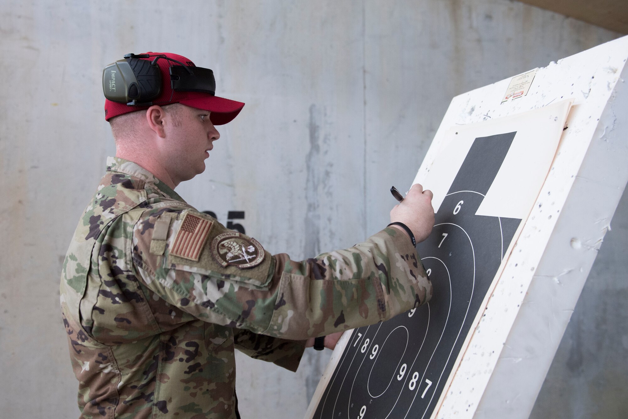Senior Airman Preston Smith, 39th Security Forces Squadron combat arms instructor, counts bullet holes on a target during a shooting competition on May 17, 2019, at Incirlik Air Base, Turkey. The 39th SFS hosted the competition as part of the 39th Air Base Wing’s Police Week observance. The purpose of Police Week is to honor the service of law enforcement officers and commemorate those who have fallen in the line of duty. (U.S. Air Force photo by Senior Airman Joshua Magbanua)