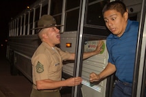 A drill instructor with Receiving Company, Support Battalion, welcomes a new recruit with India Company, 3rd Recruit Training Battalion, to recruit training during receiving at Marine Corps Recruit Depot San Diego, May 13.