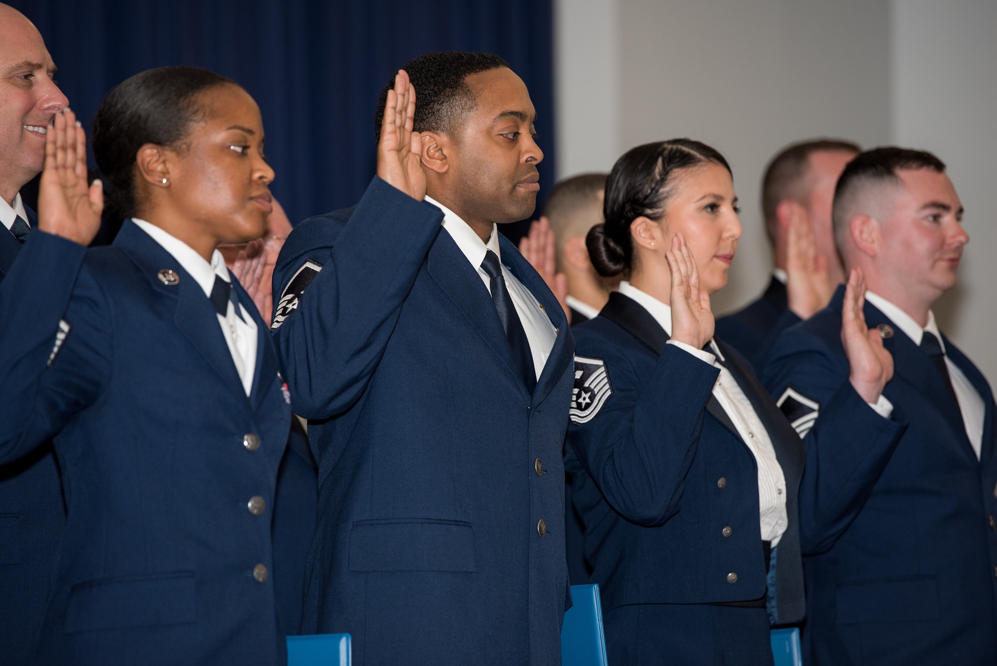 Airmen from the 512th Airlift Wing raise their right hands during a senior non-commissioned officer induction ceremony held at The Landings in Dover, Delaware, May 18, 2019. Thirty-two newly promoted master sergeants were charged with new responsibilities as they accepted the role within their new rank. (U.S. Air Force photo by Staff Sgt. Damien Taylor)