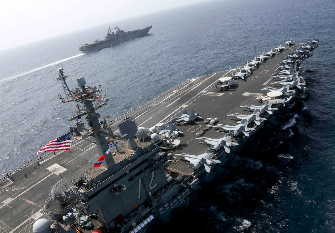 The Nimitz-class aircraft carrier USS Abraham Lincoln (CVN 72) and the Wasp-class Amphibious Assault Ship USS Kearsarge (LHD 3) sail alongside as the Abraham Lincoln Carrier Strike Group (ABECSG) and Kearsarge Amphibious Ready Group (KSGARG) conduct joint operations in the U.S. 5th Fleet area of operations. The ABECSG and KSGARG, with the 22nd Marine Expeditionary Unit, are prepared to respond to contingencies and to defend U.S. forces and interests in the region. (U.S. Navy photo by Mass Communication Specialist 1st Class Brian M. Wilbur/Released)