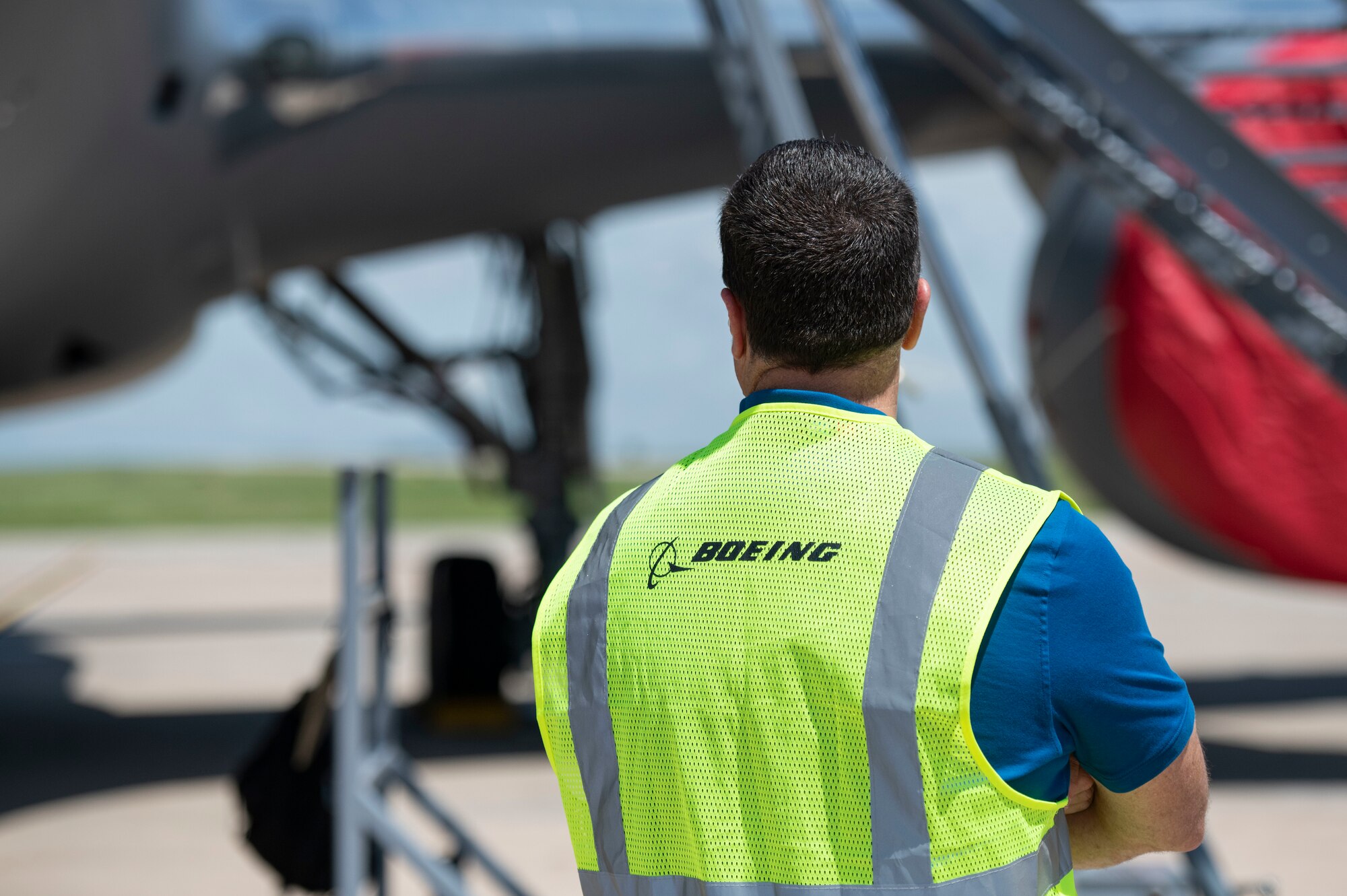 A Boeing employee looks at a newly-arrived KC-46 Pegasus, May 18, 2019, at Altus Air Force Base, Okla. The KC-46 is equipped with a refueling boom driven by new technology, allowing it to refuel almost any aircraft midflight. (U.S. Air Force photo by Airman 1st Class Breanna Klemm)