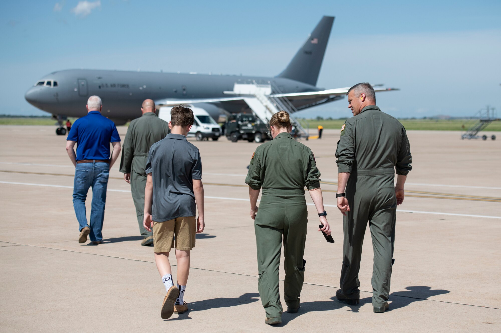 Airmen from the 97th Air Mobility Wing walk towards the newly arrived KC-46 Pegasus, May 18, 2019, at Altus Air Force Base, Okla. This plane was the second of two KC-46s to arrive at Altus AFB and marks the fifth KC-46 for the base. (U.S. Air Force photo by Airman 1st Class Breanna Klemm)