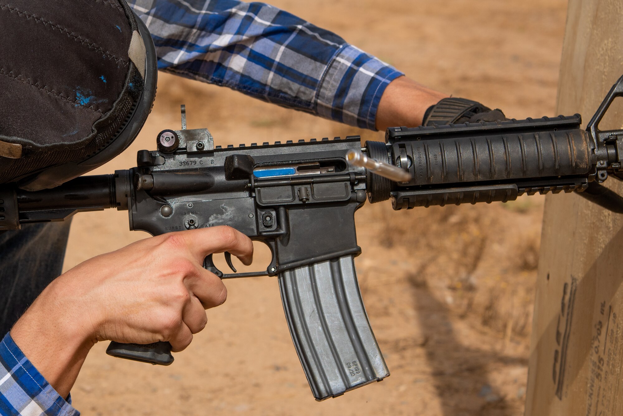 A Police Week 2019 Tactical Competition participant fires a weapon through a wall during the Police Week Tactical Competition May 16, 2019, at Luke Air Force Base, Ariz.