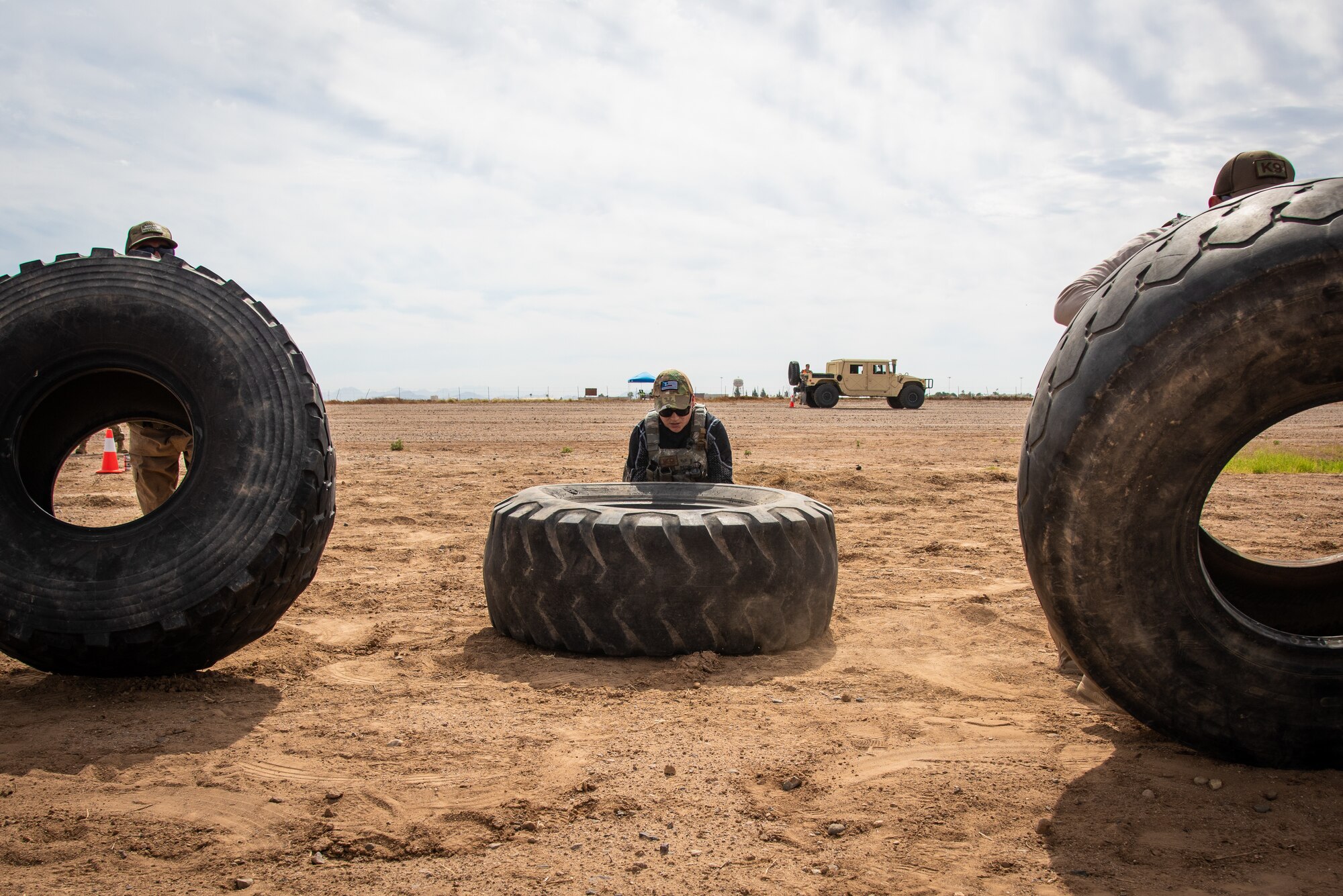 Staff Sgt. Elizabeth Pedroza, 56th Security Forces Squadron Military Working Dog handler, lifts a tire with her team members during the Police Week Tactical Competition May 16, 2019, at Luke Air Force Base, Ariz.