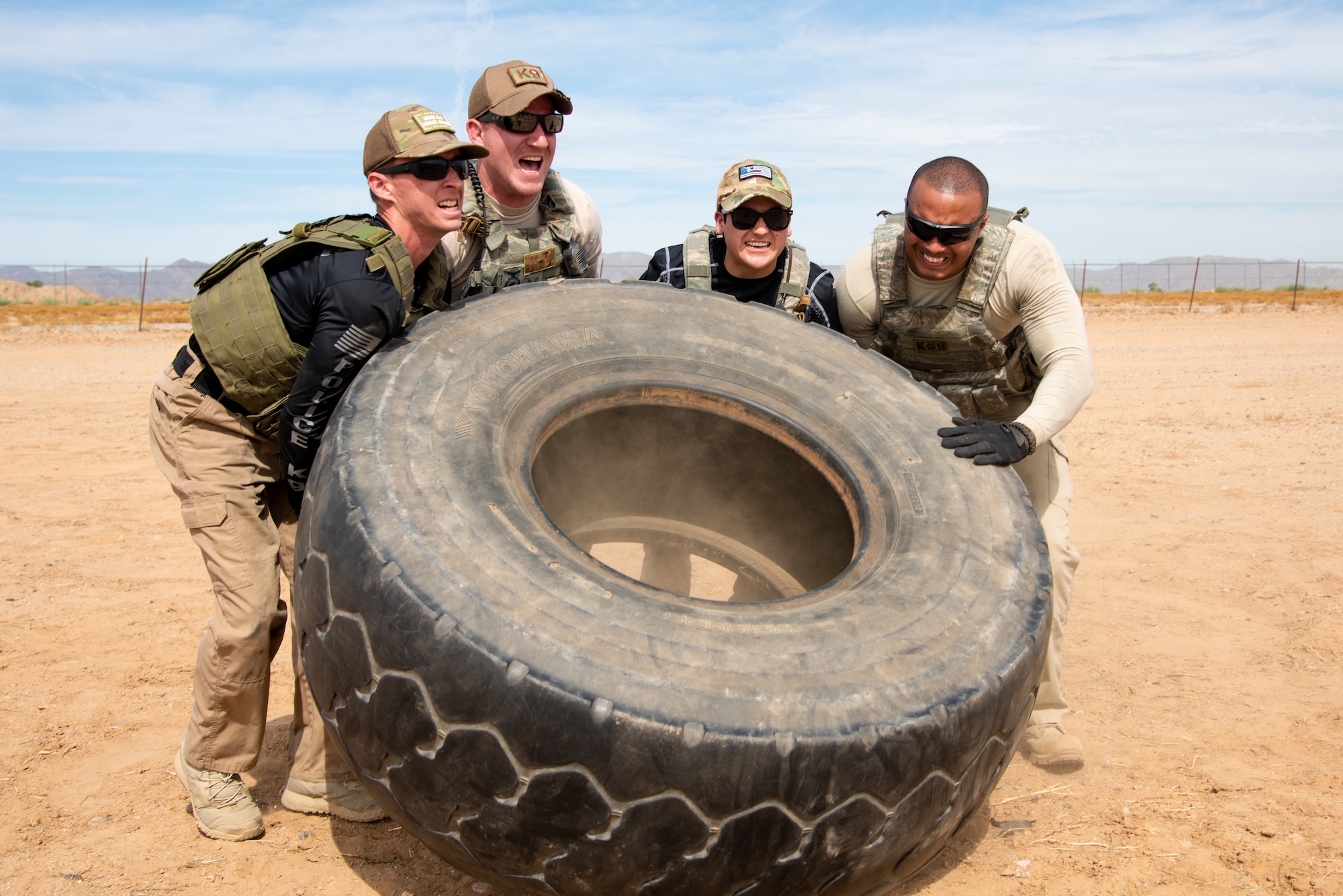 Airmen assigned to the 56th Security Forces Squadron work together to lift a tire during the Police Week Tactical Competition May 16, 2019, at Luke Air Force Base, Ariz.