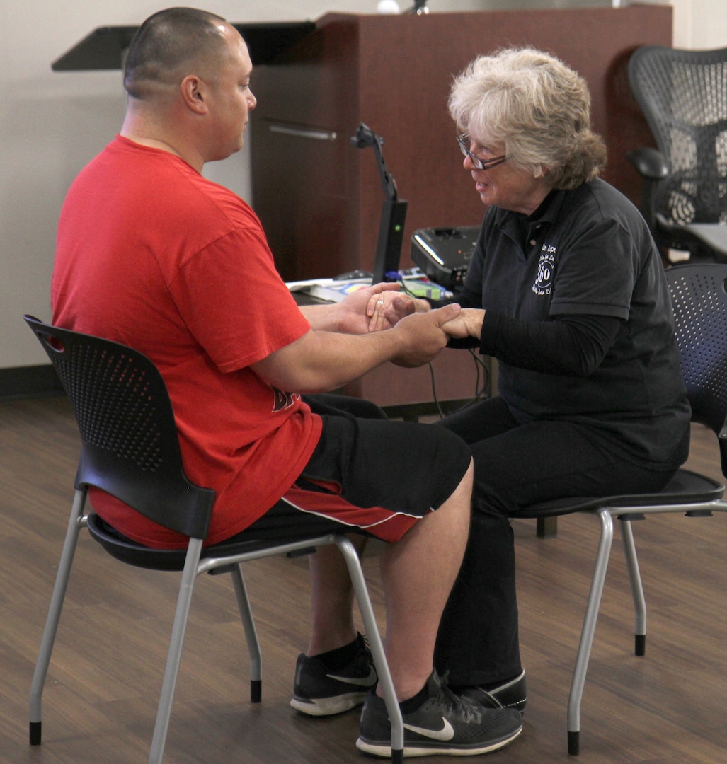 Dr. Mary Lopez, a retired Army colonel and 360° Program co-founder, engages in an exercise called “3-by-3” with Staff Sgt. Peter Tuinei-Flora, 56th Signal Battalion, during the 360° Leader Program at the Vogel Resiliency Center at Joint Base San Antonio-Fort Sam Houston May 15. The purpose of the exercise is to open good communication lines between spouses by sitting knee-to-knee and allowing one spouse to speak for three minutes without interruption.
