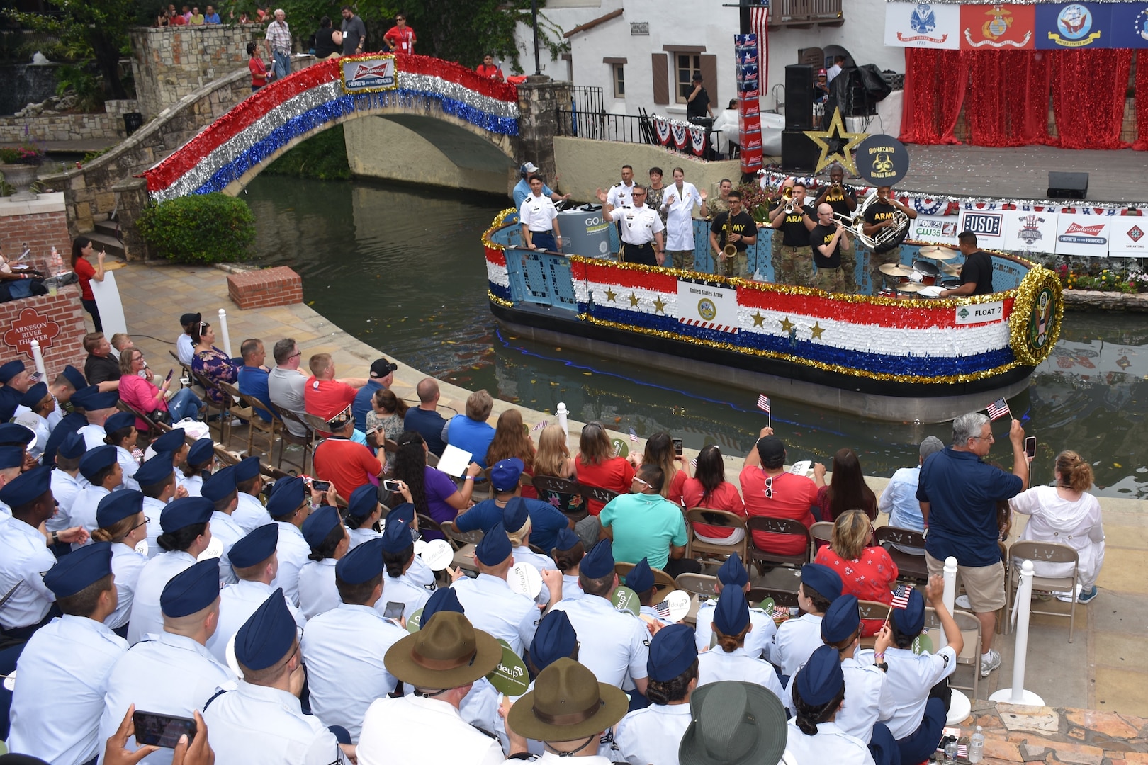 Military members from Joint Base San Antonio enjoy the festivities at the Arneson River Theater during the annual Armed Forces River Parade May 18 in downtown San Antonio. This year's theme was "Salute Our Heroes." The parade promotes awareness of the joint presence and ties to the military families and community. Representing the U.S. Army in this year's parade were Brig. Gen. Bill Boruff, Mission and Installation Contracting Command commanding general; MICC Command Sgt. Maj. Marcos Torres, and Capt. Jim Jimenez, aide de camp for the MICC commanding general.