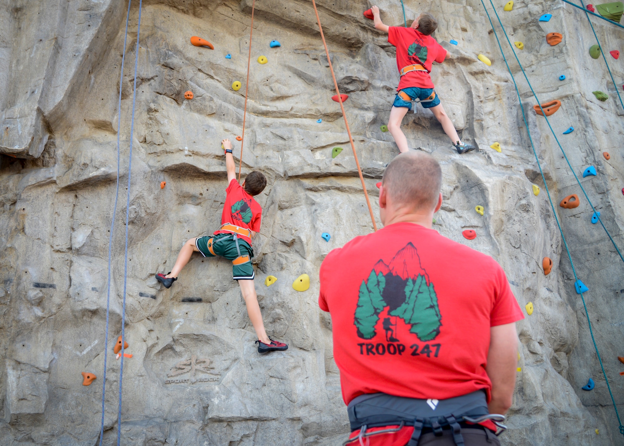 Boy Scout Troop 247 Scout Master, Scott Spann belays a Boy Scout during a rock climbing training event at the Oasis Community Center on Edwards Air Force Base, Calif., May 14. The Scouts are conducting training in order to obtain their badges during testing later this summer. For more information about joining the local Boy Scout Troop 247, E-mail troop247.boyscouts@gmail.com or visit https://beascout.scouting.org. (U.S. Air Force photo by Giancarlo Casem)