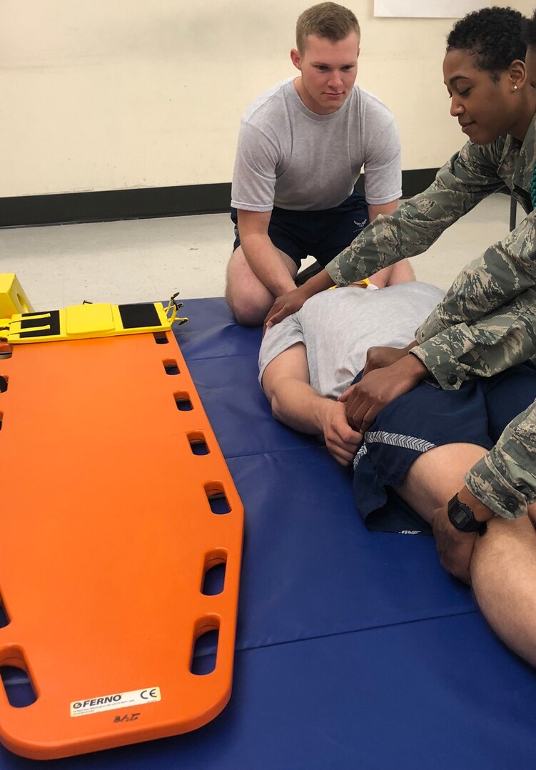 Airman 1st Class Colten Connelly simulates a c-spine stabilization on a “patient” during emergency medical technician training in the Aerospace Service Medical Apprentice program at the Medical Education and Training Campus. The technique is the same one he administered to a vehicle accident victim. The purpose of this skill is to prevent further injury to patients involved in a trauma. When this skill is completed appropriately, the patient is unable to move and will stay on the backboard until a physician evaluates them for spinal injuries.